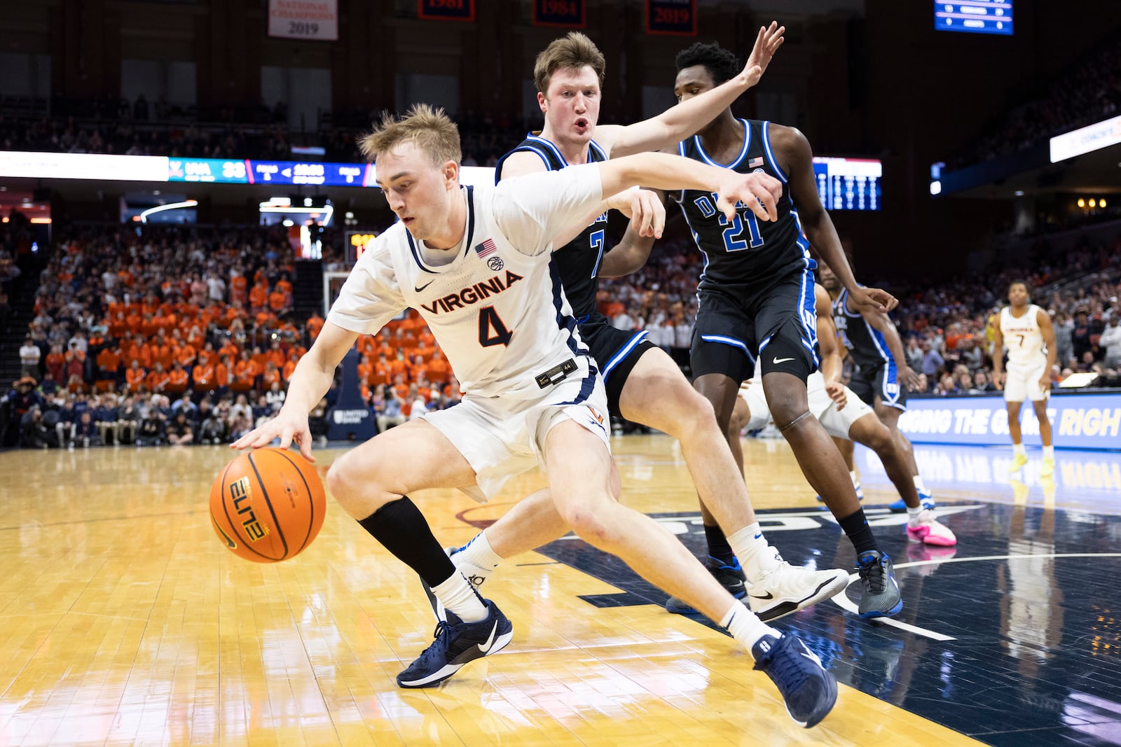 Virginia guard Andrew Rohde (4) defends the ball from Duke guard Kon Knueppel during the second half of an NCAA college basketball game, Monday, Feb. 17, 2025, in Charlottesville, Va. (AP Photo/Mike Kropf)