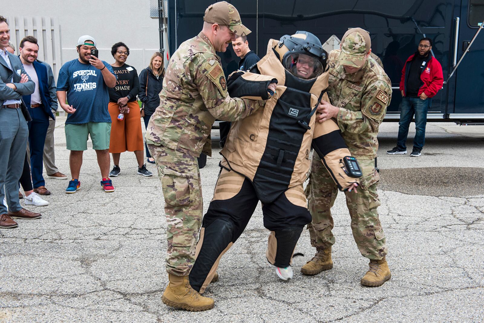 Explosive ordinance technicians from Wright-Patterson Air Force Base assist a volunteer from Leadership Dayton with wearing an EOD suit during a demonstration April 13 at Wright-Patterson Air Force Base. U.S. AIR FORCE PHOTO/JAIMA FOGG