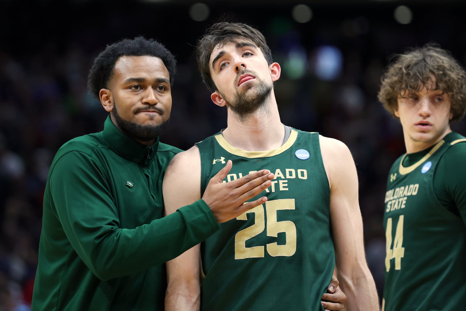 Colorado State guard Ethan Morton (25) is comforted by graduate assistant Anthony Holland after the team's loss to Maryland during the second half in the second round of the NCAA college basketball tournament, Sunday, March 23, 2025, in Seattle. (AP Photo/Ryan Sun)