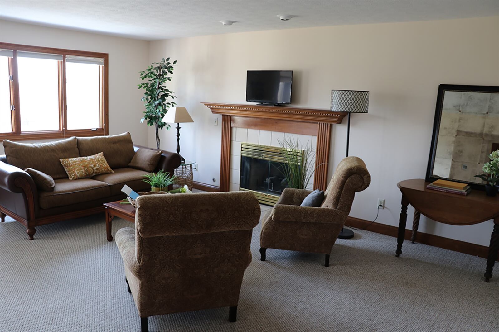 The family room has a picture window that looks out over the deep terrace back yard. A gas fireplace has a fluted wood mantel and ceramic-tile surround and hearth. CONTRIBUTED PHOTO BY KATHY TYLER