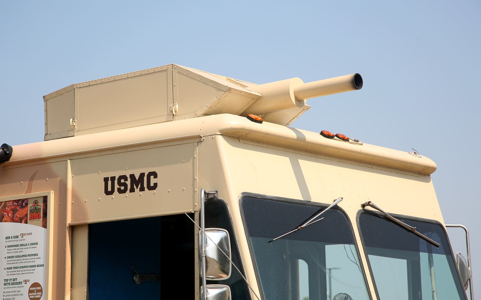 Caption: Scott Green, a Marine who served from 2001 - 2005, and is the owner of the Dayton Urban BBQ food truck,  retrofitted his 1989 Ford box truck to resemble an assault amphibious vehicle.  LISA POWELL / STAFF