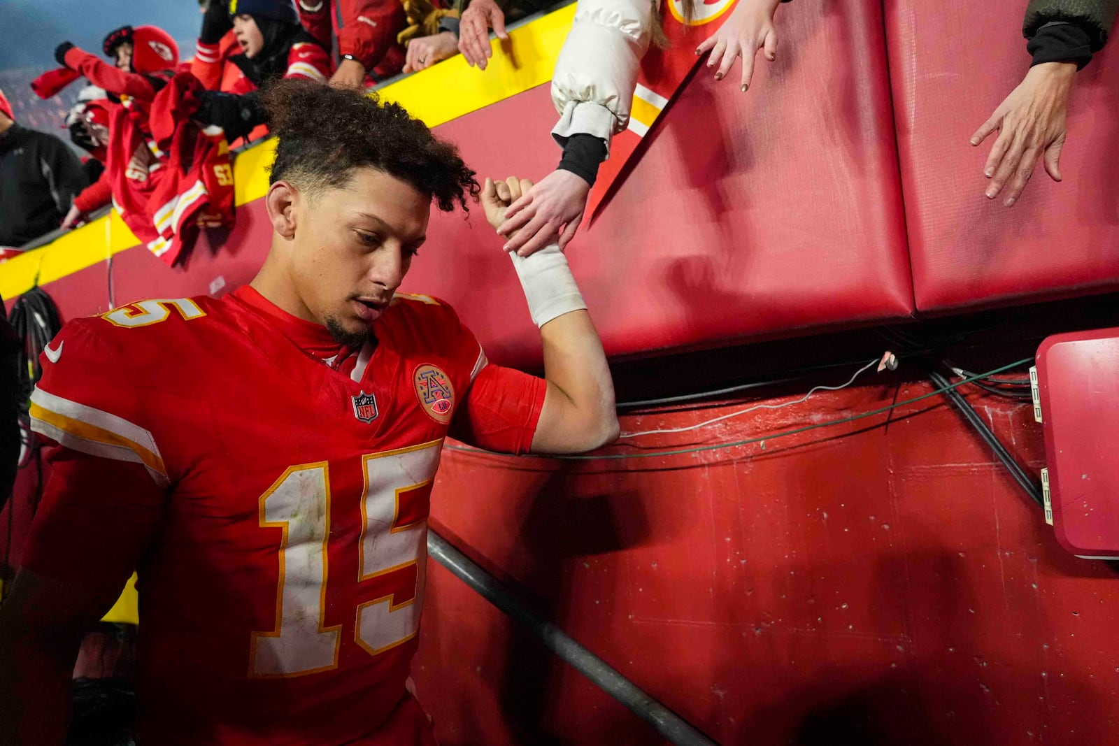 Kansas City Chiefs quarterback Patrick Mahomes (15) greets fan following an NFL football game against the Las Vegas Raiders in Kansas City, Mo., Friday, Nov. 29, 2024. (AP Photo/Charlie Riedel)