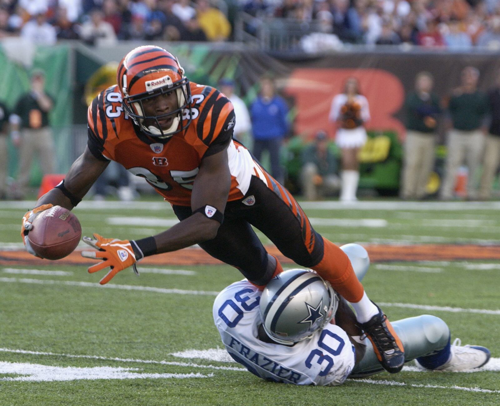 CINCINNATI - NOVEMBER 7:  Wide receiver Chad Johnson #85 of the Cincinnati Bengals is tackled by cornerback Lance Frazier #30 of the Dallas Cowboys during the game at Paul Brown Stadium on November 7, 2004 in Cincinnati, Ohio. The Bengals defeated the Cowboys 26-3. (Photo by Andy Lyons/Getty Images)