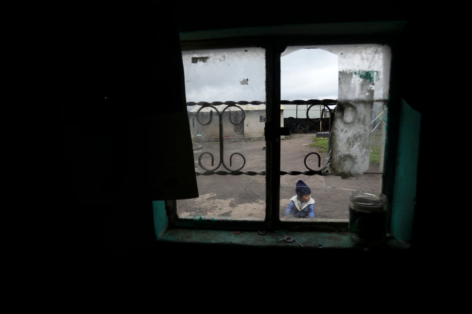 A child plays in his backyard in Cochapamba, Ecuador, Tuesday, Feb. 11, 2025, ahead of the presidential run-off election. (AP Photo/Dolores Ochoa)