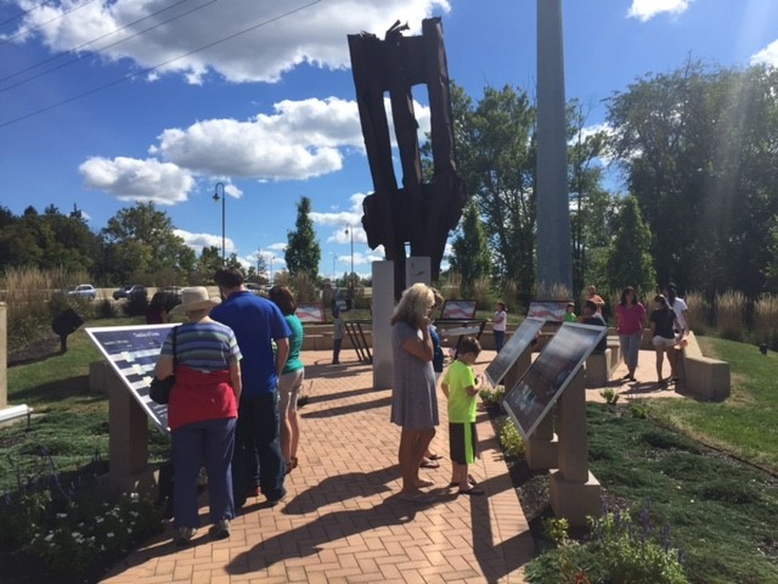 Visitors at the Beavercreek 9/11 Memorial on North Fairfield Road honor the 15th anniversary of 9/11 on Sunday, Sept. 11, 2016. DEANGELO BYRD / STAFF