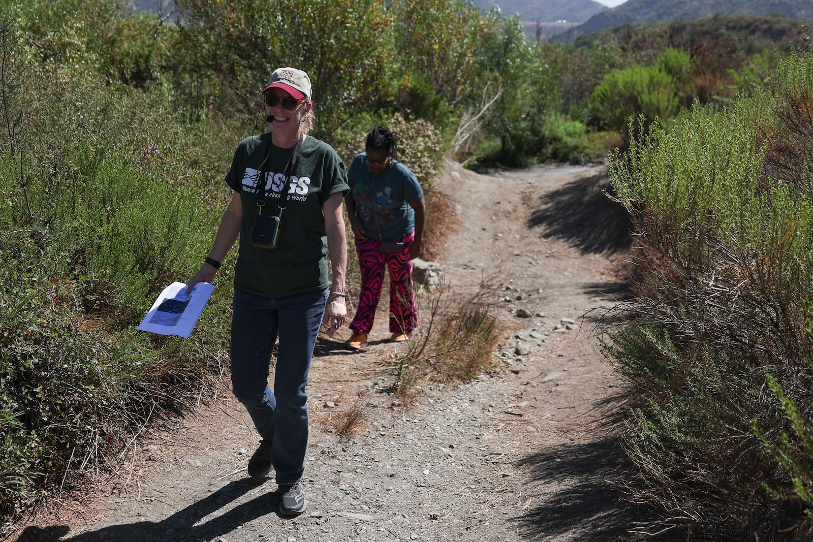 Kate Scharer, a research geologist with the Earthquake Science Center of the US Geological Survey, left, walks with Shirley Jackson, an adjunct professor of general geology at York College, during an accessible field trip to the San Andreas Fault organized by the International Association of Geoscience Diversity Thursday, Sept. 26, 2024, in San Bernadino, Calif. (AP Photo/Ryan Sun)