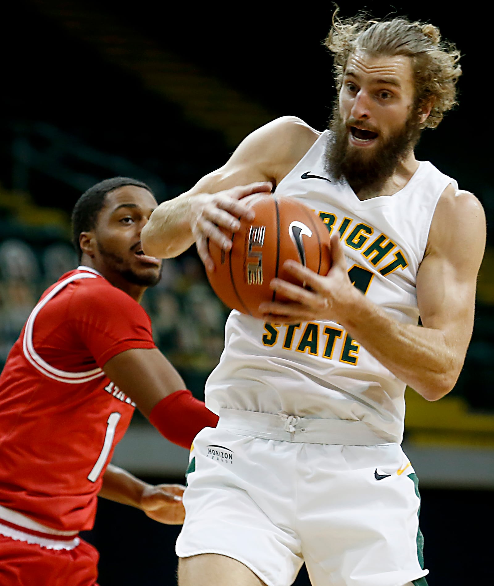 Wright State guard Tim Finke pulls down a defensive rebound in front of Miami forward Josh Brewer during a mens basketball game at the Nutter Center in Fairborn Saturday, Dec. 5, 2020. E.L. Hubbard/CONTRIBUTED