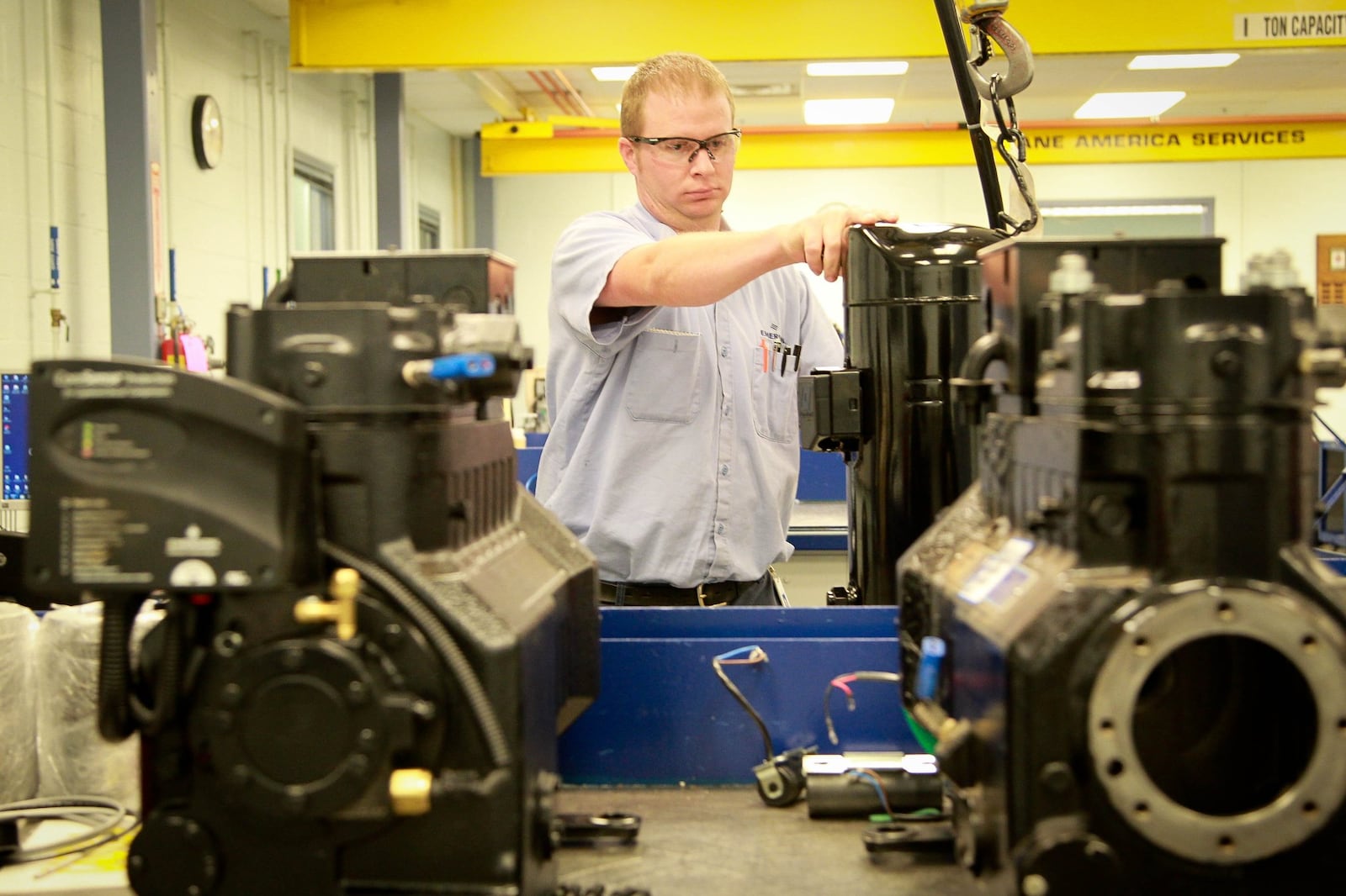 Eric Schoen, an Emerson technician, works in the assembly lab at the facility in Sidney. JIM WITMER / STAFF