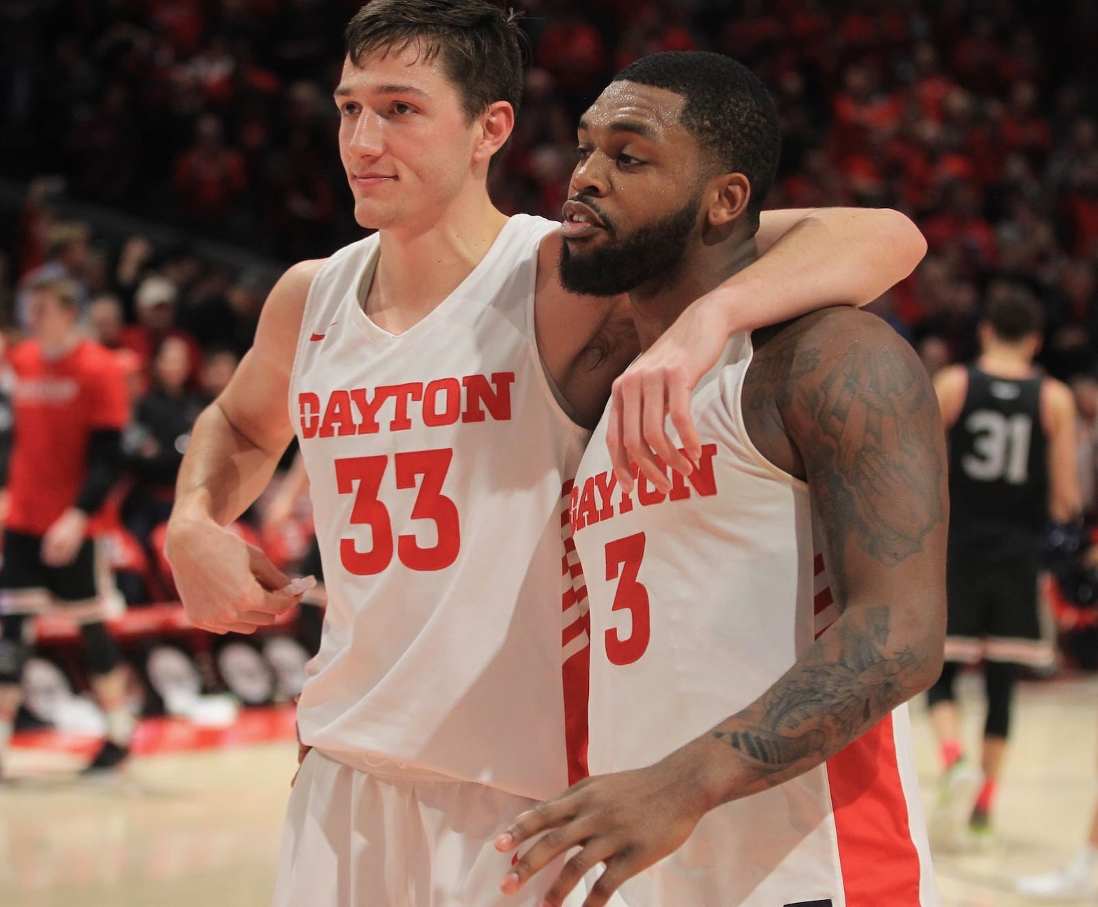 Dayton’s Ryan Mikesell and Trey Landers leave the court after a victory against Davidson on Friday, Feb. 28, 2020, at UD Arena. David Jablonski/Staff