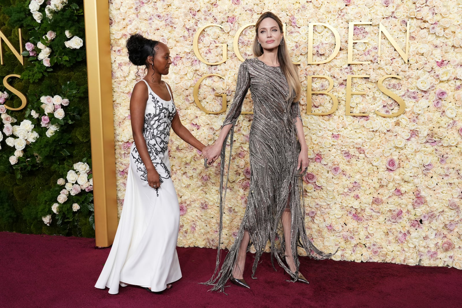 Zahara Jolie, left, and Angelina Jolie arrive at the 82nd Golden Globes on Sunday, Jan. 5, 2025, at the Beverly Hilton in Beverly Hills, Calif. (Photo by Jordan Strauss/Invision/AP)