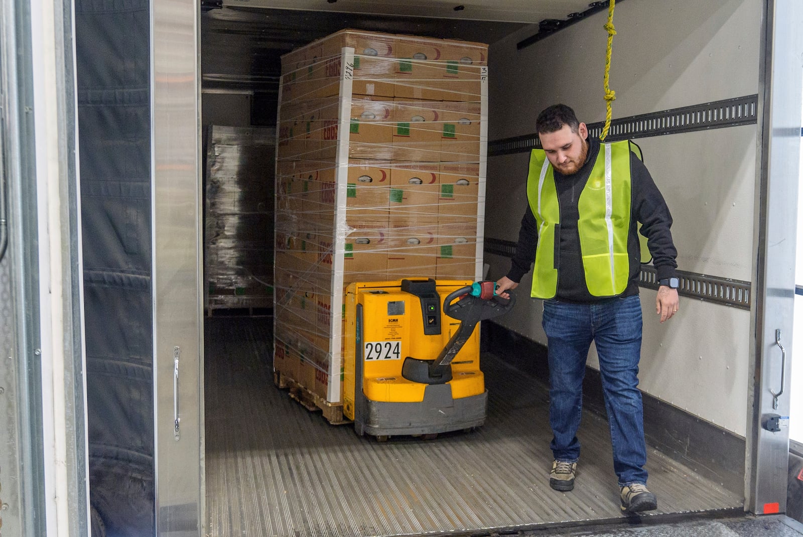 Rosemary Farm's driver Jose Pelayo unloads a truck with some of the hundreds of thousands of fresh eggs donated to feed first responders and those in need in the community through the donation of Rosemary Eggs at the Los Angeles Food Regional Bank in City of Industry, Calif., Wednesday, Feb. 12, 2025. (AP Photo/Damian Dovarganes)