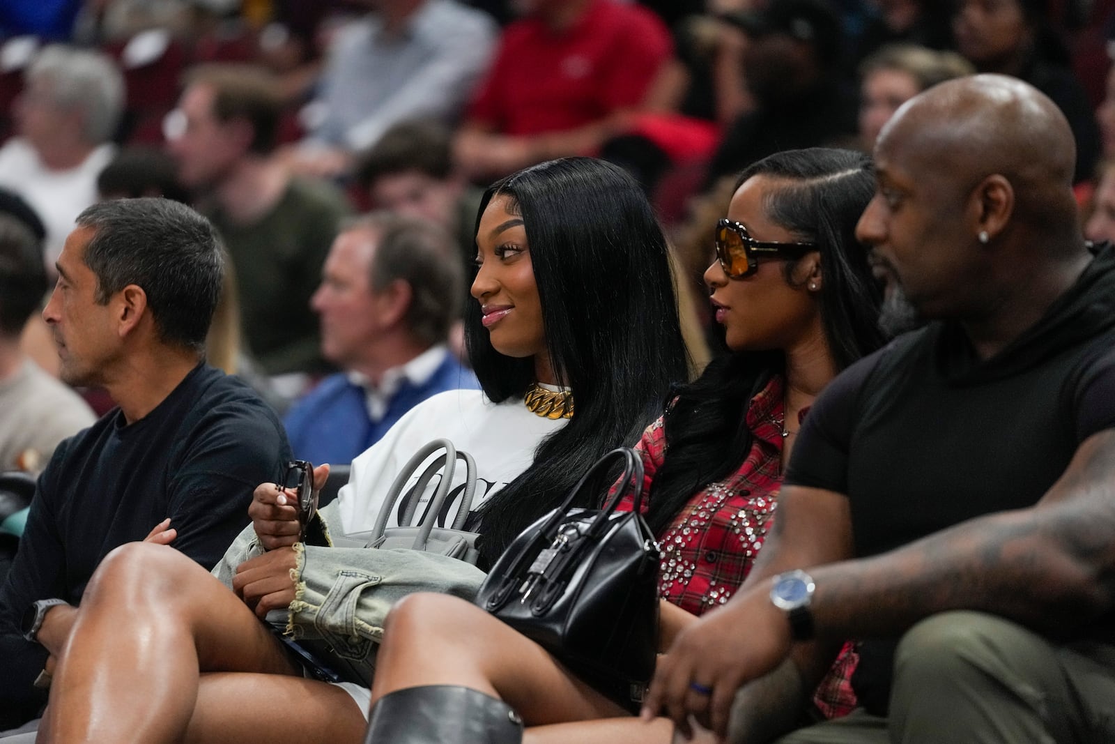 Angel Reese of the WNBA's Chicago Sky sits courtside during the first half of an NBA basketball game between the Orlando Magic and Chicago Bulls, Wednesday, Oct. 30, 2024, in Chicago. (AP Photo/Erin Hooley)