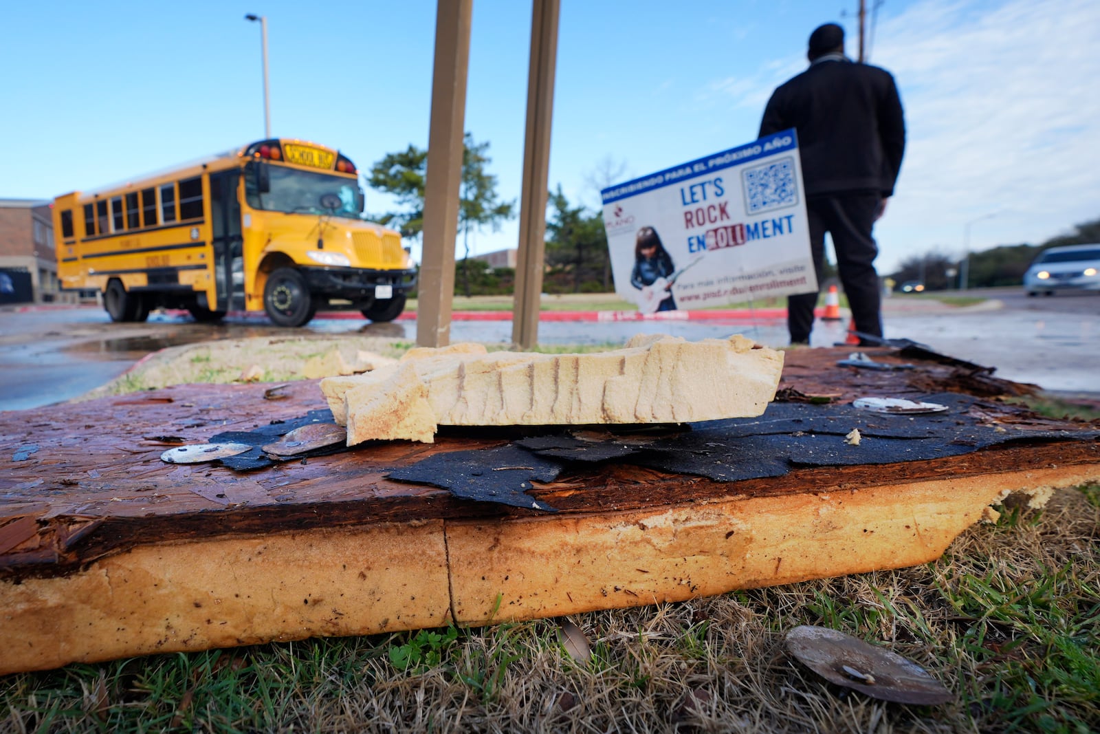 Storm debris sits in front of Plano West High School Tuesday, March 4, 2025, in Plano, Texas. (AP Photo/LM Otero)