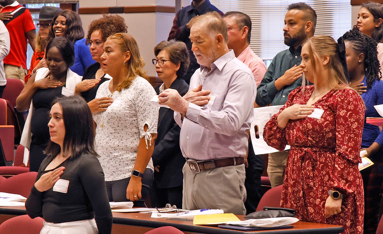 Immigrants said the Oath of Allegiance to the United States of America during their naturalization ceremony Monday, Sept. 18, 2023 at the University of Dayton School of Law. BILL LACKEY/STAFF