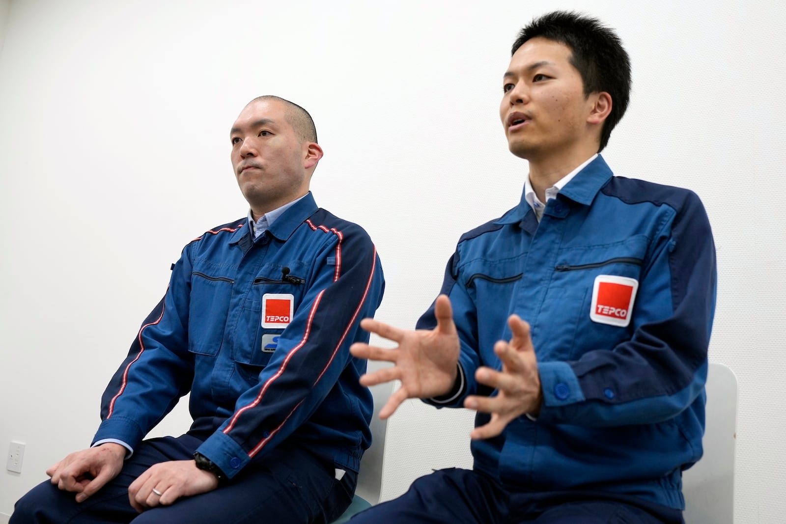 Yasunobu Yokokawa, left, and Hiroshi Ide, right, who both are members of the Fuel Debris Retrieval Program Department at the Fukushima Daiichi and supervisors on the ground during the debris removal last year, speak during an interview with The Associated Press at the Fukushima Daiichi nuclear power plant, operated by Tokyo Electric Power Company Holdings (TEPCO), in Okuma town, northeastern Japan on Monday Feb. 20, 2025. (AP Photo/Eugene Hoshiko)