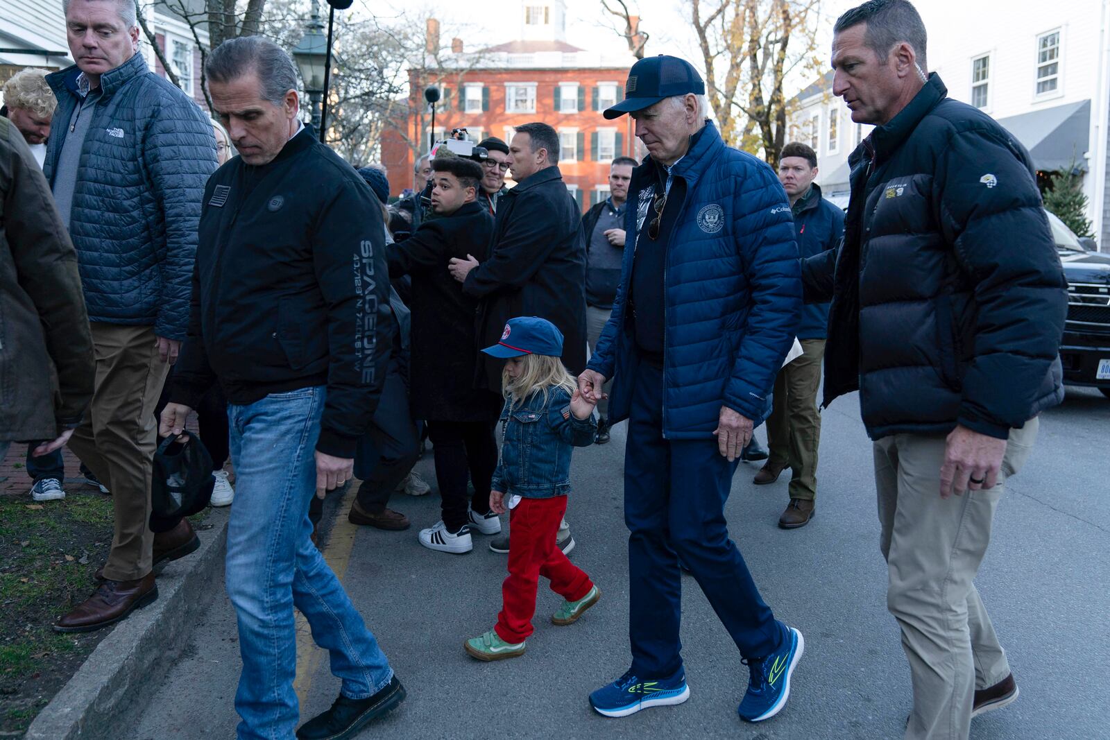 President Joe Biden, center right, holds hands with his grandson Beau as they walk with Hunter Biden, left, in downtown Nantucket Mass., Friday, Nov. 29, 2024. (AP Photo/Jose Luis Magana)