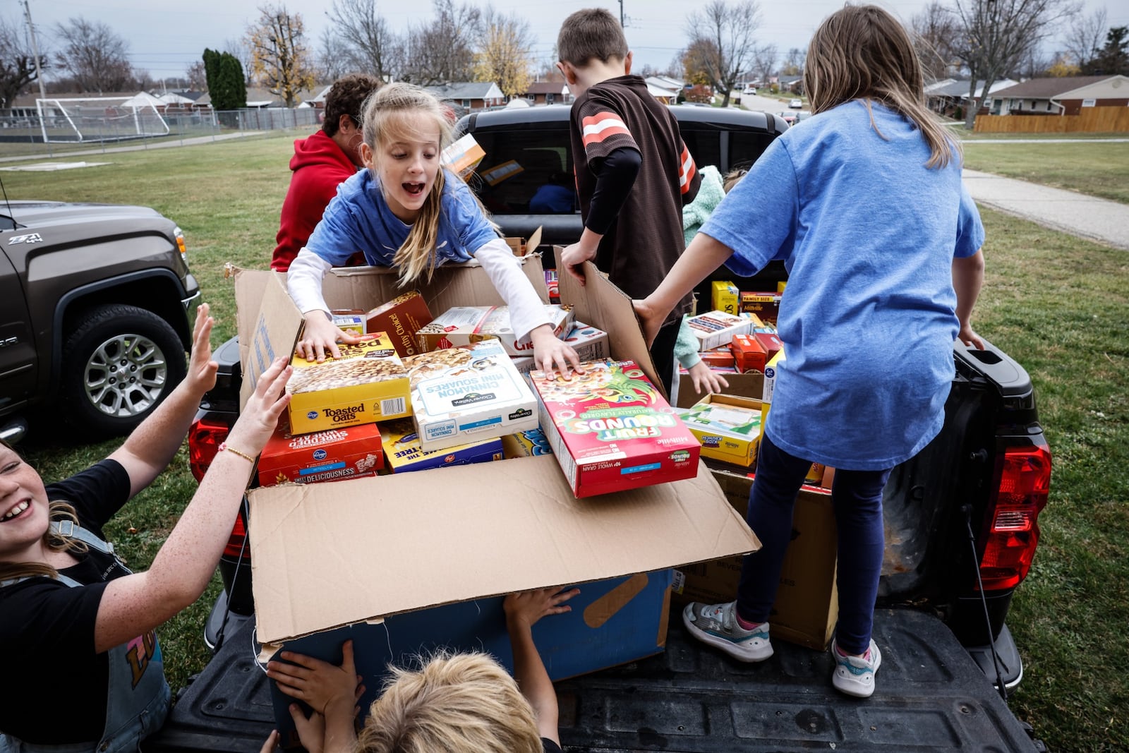 Third graders from Brookville Elementary load trucks with 900 boxes of cereal that will go to the FISH food pantry of Brookville Monday November 20, 2023. Students district wide collect over 6000 items form the pantry. Jim Noelker/Staff