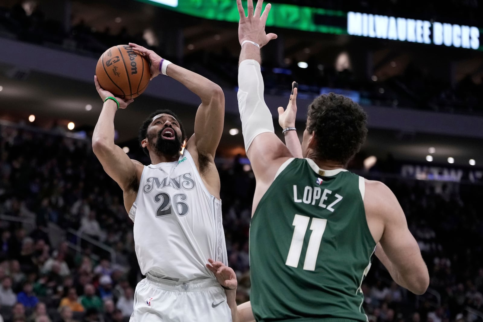 Dallas Mavericks' Spencer Dinwiddie tries to shoot over Milwaukee Bucks' Brook Lopez during the first half of an NBA basketball game Wednesday, March 5, 2025, in Milwaukee. (AP Photo/Morry Gash)