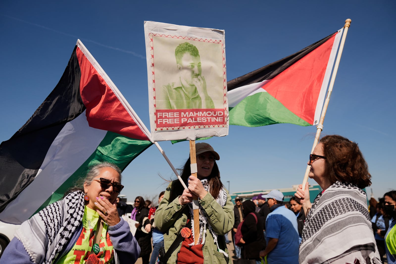 Protesters hold a sign for Mahmoud Khalil, a recently detained Palestinian activist, in Newark, N.J., Tuesday, March 11, 2025. The protest was held in front of Delaney Hall, the proposed site of an immigrant detention center. (AP Photo/Seth Wenig)