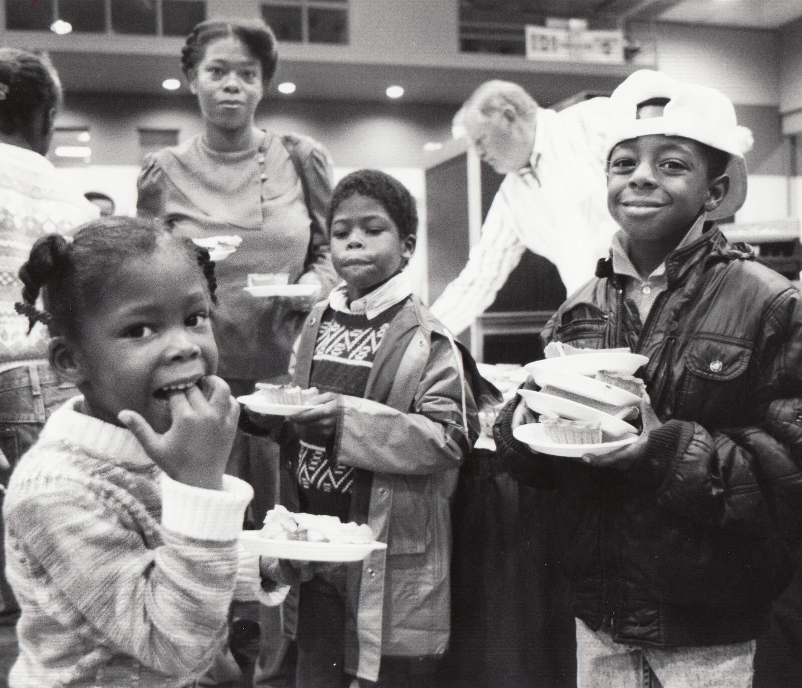 Denise Kelly and her daughter Arlane, 4, and nephews Jamahl and Avon Stokes enjoy the 1990 Beerman Thanksgiving dinner. DAYTON DAILY NEWS ARCHIVE