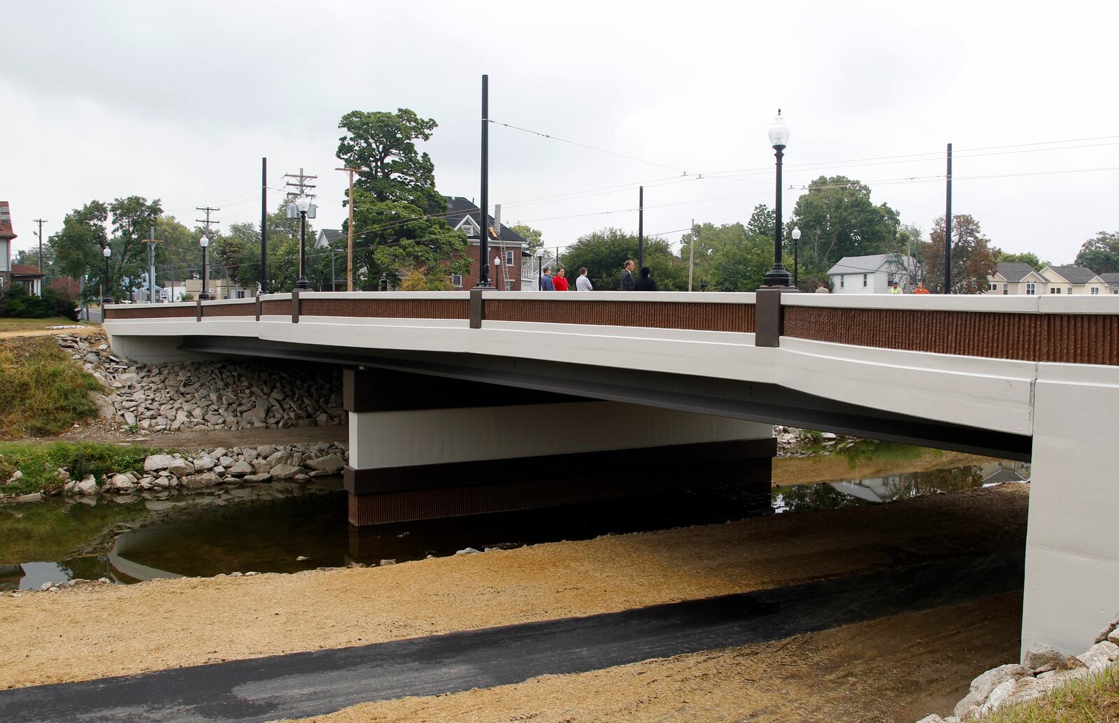 The new Broadway St. bridge over Wolf Creek in Dayton opened Monday morning. The bridge is 180 feet long  and has sidewalks that are ten feet wide with pedestrian plazas in the middle and at either end. This $2.4 million bridge is the latest of nine bridges constructed by the City of Dayton in a $53 year bridge replacement initiative.  LISA POWELL / STAFF