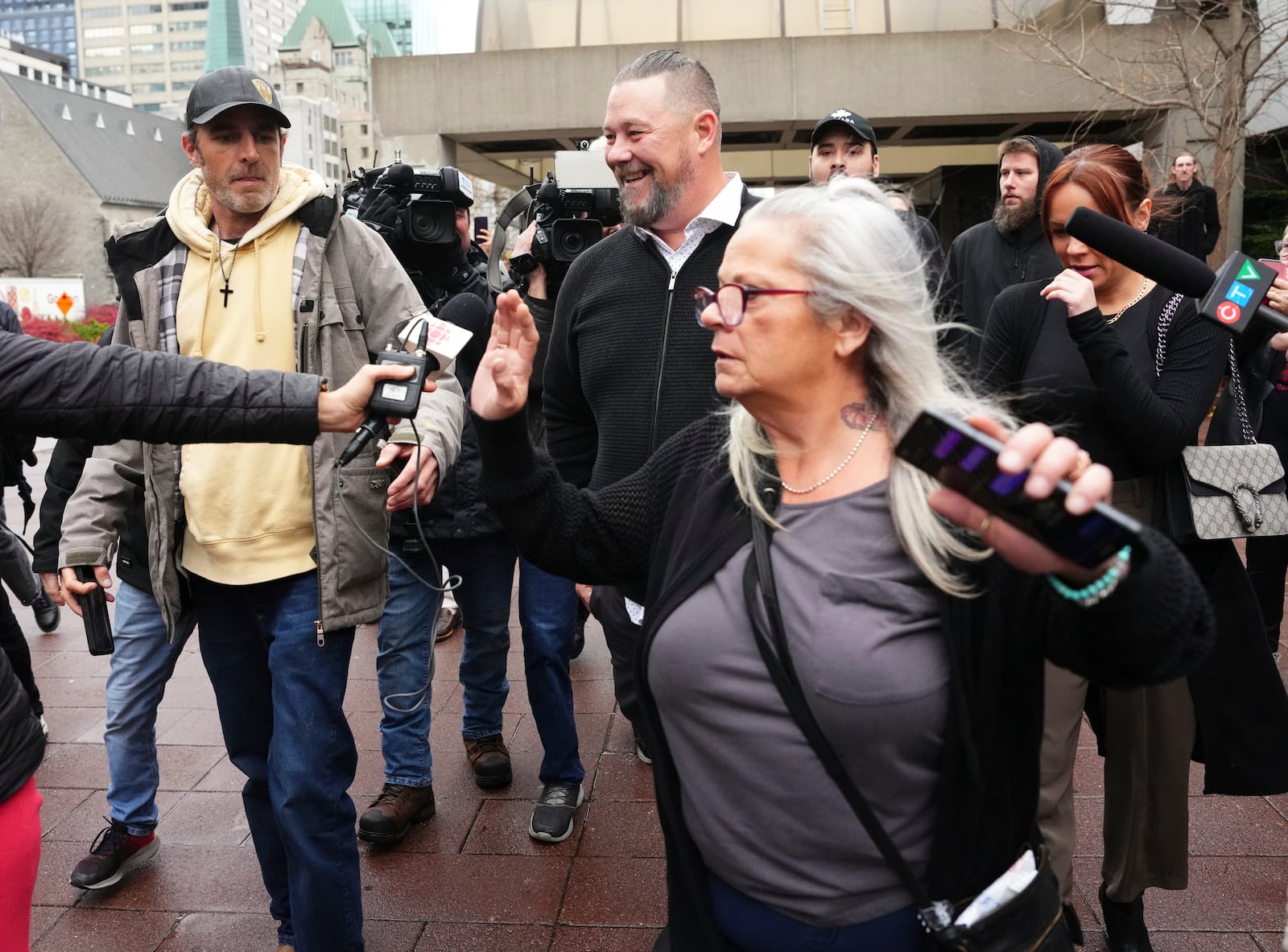 Pat King, rear center, a prominent figure in Canada’s trucker protests against COVID-19 restrictions in 2022, is joined by supporters as he leaves court in Ottawa, Ontario, Friday, Nov. 22, 2024. (Sean Kilpatrick/The Canadian Press via AP)