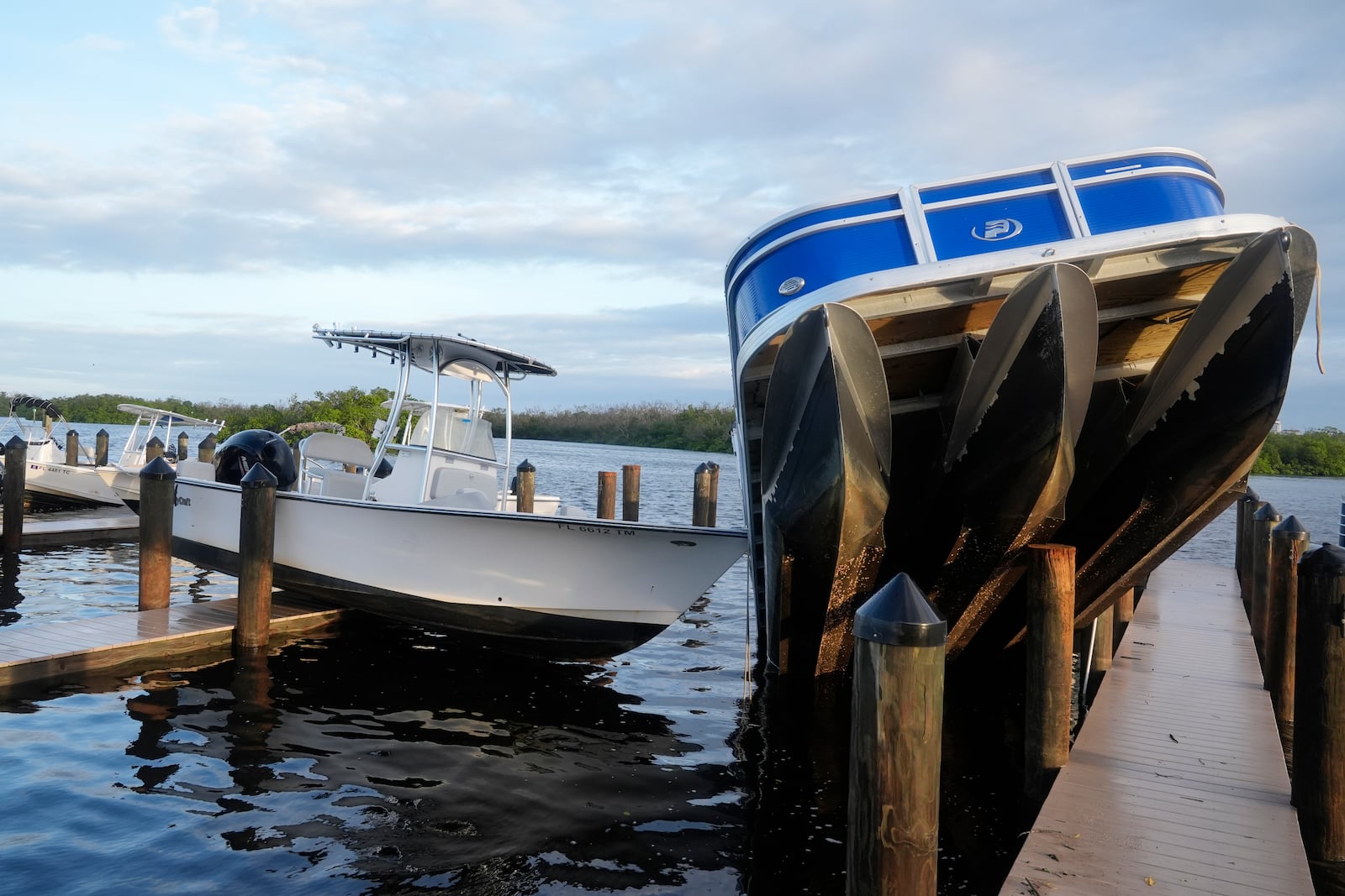 Small boats rests on a peer after they were unmoored during Hurricane Milton, Thursday, Oct. 10, 2024, in Fort Myers, Fla. (AP Photo/Marta Lavandier)