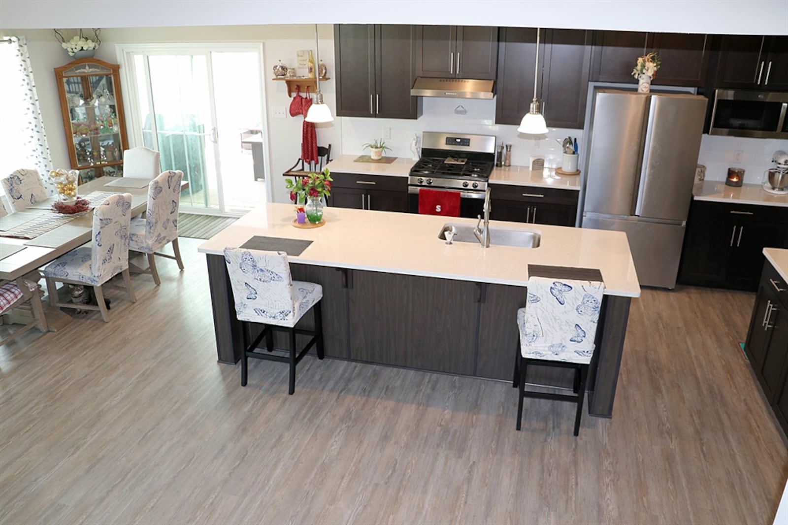 A large island with seating for four divides the kitchen from the rest of the living area. The island has a sink, storage and dishwasher within the kitchen side.