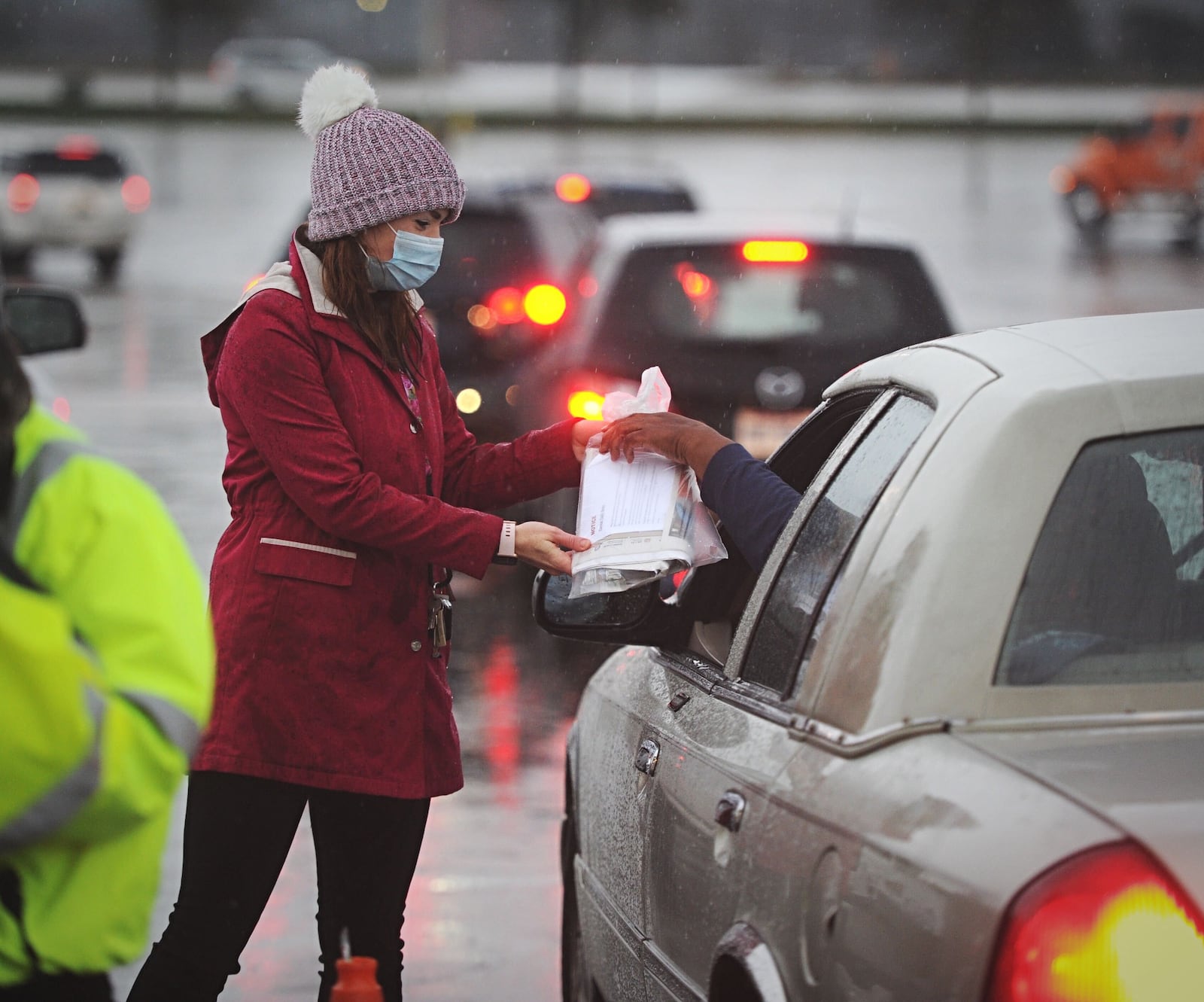 People braved a cold and chilly morning to line up for free Thanksgiving meals Wednesday morning. The turkey dinner takeaway is through Miami Valley Meals in collaboration with the MVM Coalition. Cars  lined up at UD Arena and Trotwood Madison High School for the packaged meals. MARSHALL GORBY/STAFF