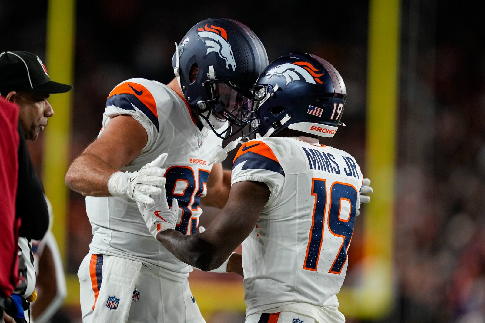 Denver Broncos wide receiver Marvin Mims Jr. (19) celebrates a touchdown with Denver Broncos tight end Lucas Krull (85) against the Cincinnati Bengals during the second half of an NFL football game in Cincinnati, Saturday, Dec. 28, 2024. (AP Photo/Carolyn Kaster)