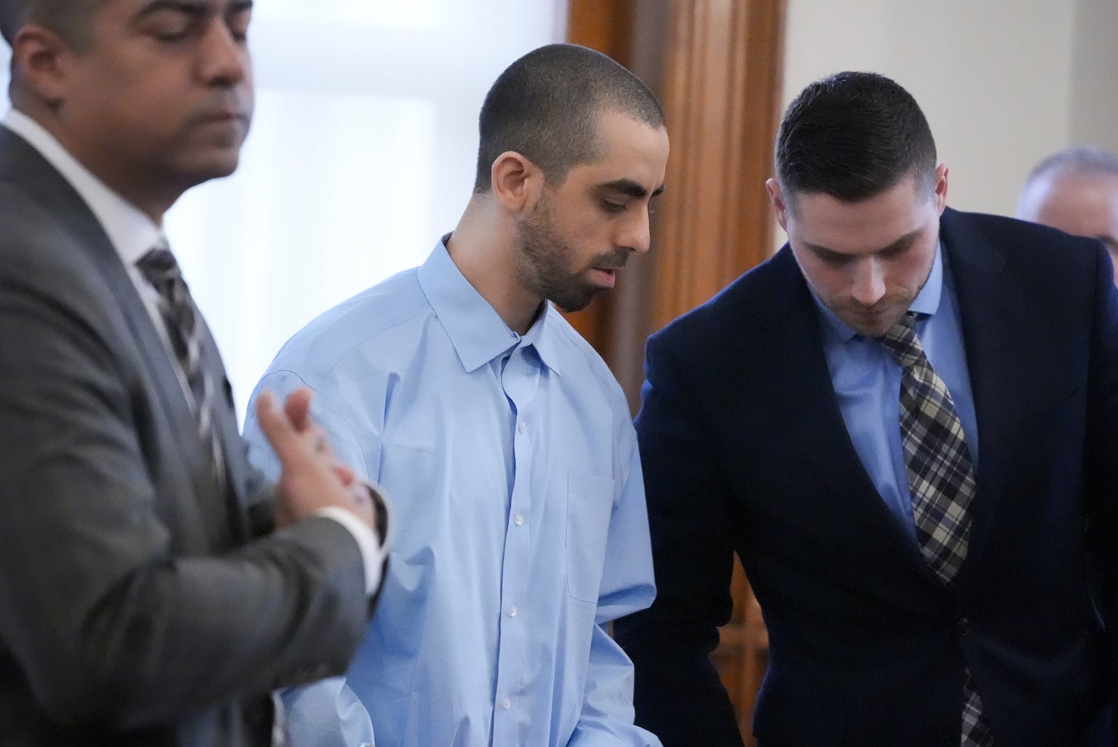 Hadi Matar, center, stands at the defense table with his attorneys before the start of the second day of his trial at the Chautauqua County Courthouse, Tuesday, Feb. 11, 2025, in Mayville, N.Y. Matar is charged with stabbing famed author Salman Rushdie. (AP Photo/Gene J. Puskar)