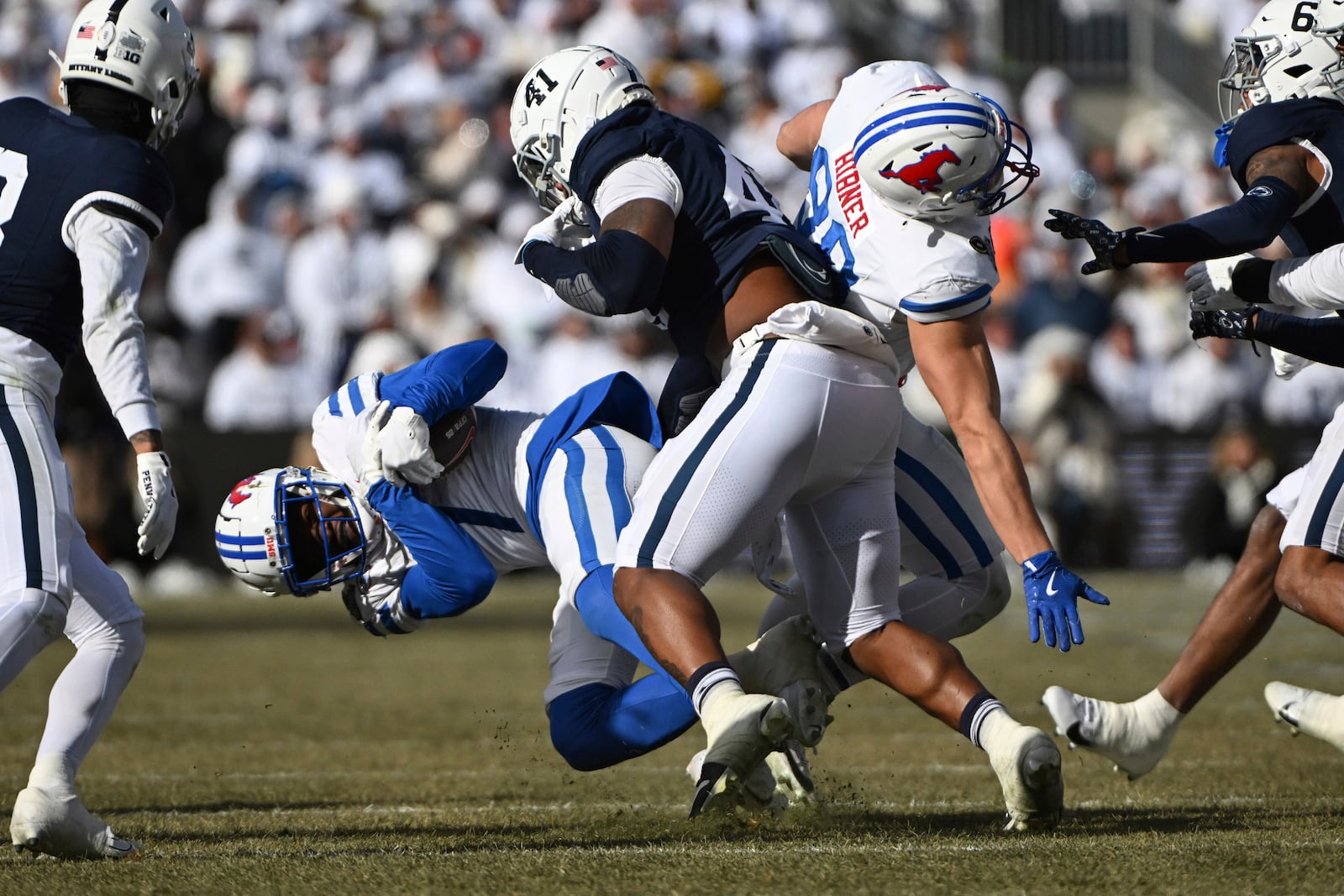 Penn State linebacker Kobe King tackles SMU running back Brashard Smith (1) during the first half in the first round of the College Football Playoff, Saturday, Dec. 21, 2024, in State College, Pa. (AP Photo/Barry Reeger)