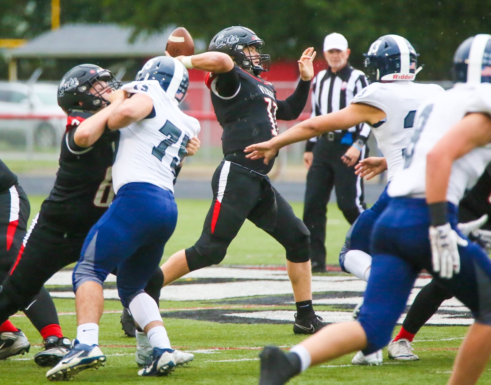 Franklin quartback Braden White (11) prepares to launch a pass against Edgewood during Friday night’s game at Atrium Stadium in Franklin. GREG LYNCH/STAFF