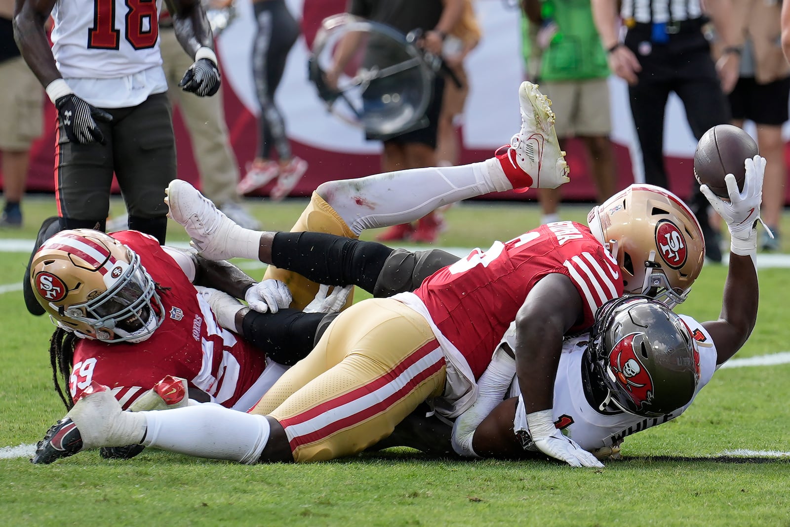 Tampa Bay Buccaneers running back Rachaad White, bottom right, reacts after scoring a touchdown against San Francisco 49ers linebacker De'Vondre Campbell, bottom left, and safety Malik Mustapha during the second half of an NFL football game in Tampa, Fla., Sunday, Nov. 10, 2024. (AP Photo/Chris O'Meara)