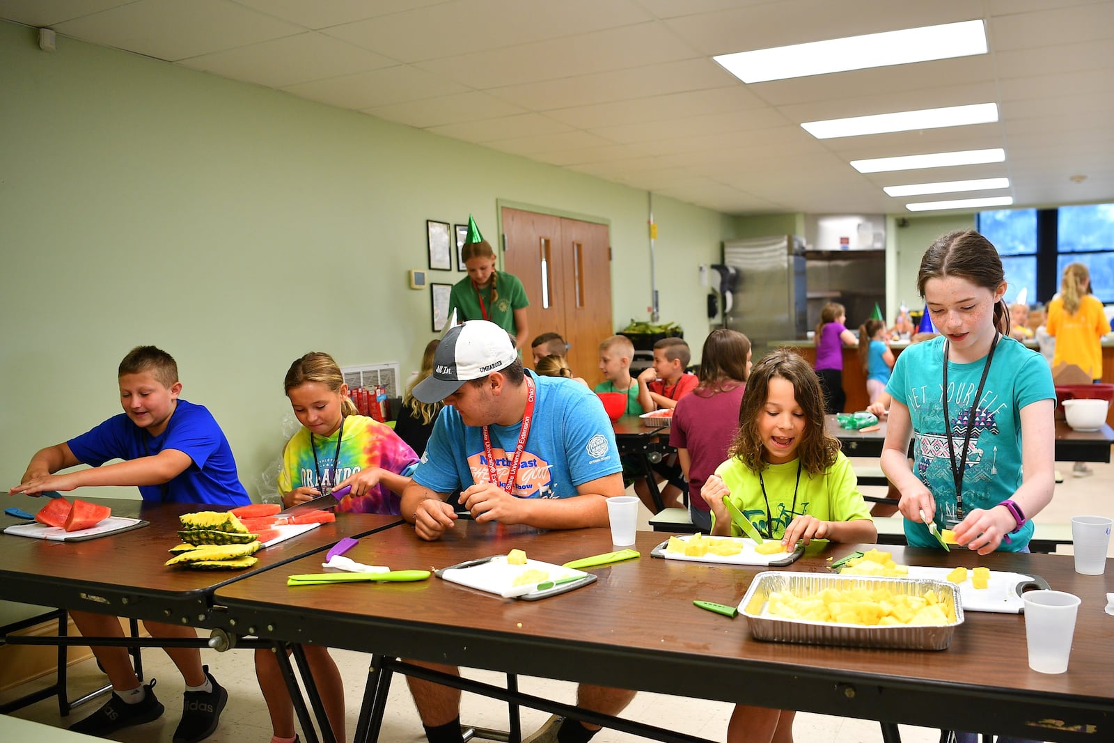 Miami County youth prepare fruit for a charcuterie board project during this year's Jr. Chef program offered through the county Ohio State University Extension Office.  Contributed