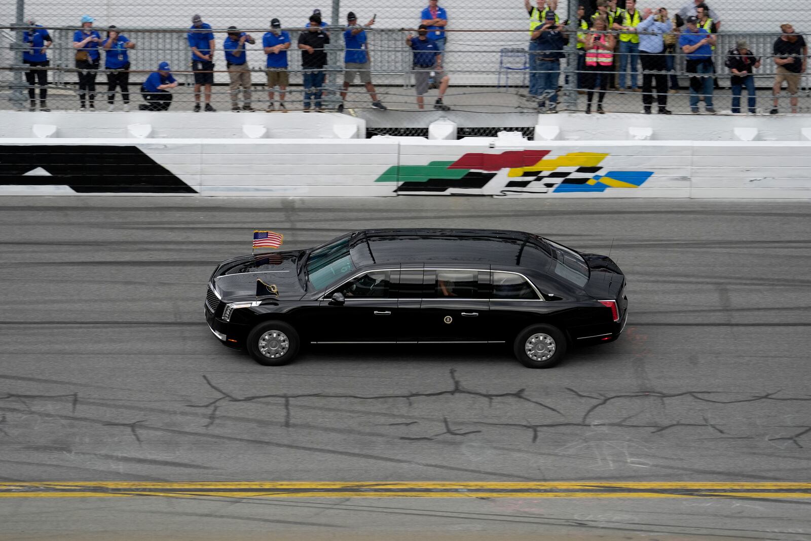 President Donald Trump rides in the presidential limousine known as "The Beast" as he takes a pace lap ahead of the start of the NASCAR Daytona 500 auto race at Daytona International Speedway, Sunday, Feb. 16, 2025, in Daytona Beach, Fla. (AP Photo/Chris O'Meara)