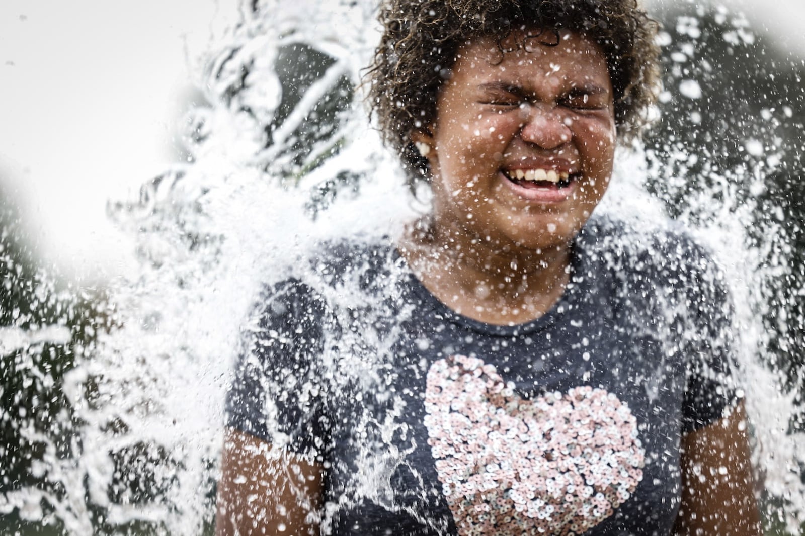 Frost Anderson, from Dayton, enjoys the splash pad at W.S. Mcintosh Park in Dayton. Temperatures are expected to reach the 90s this week. JIM NOELKER/STAFF