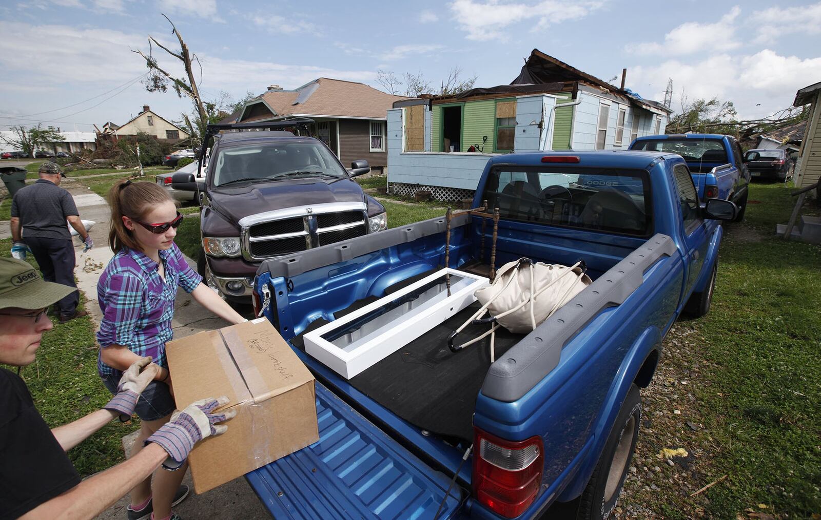 Griffen and Hailey Sander load the belongings of their family friend Christine Creager, whose home lost its roof in the tornado. TY GREENLEES / STAFF