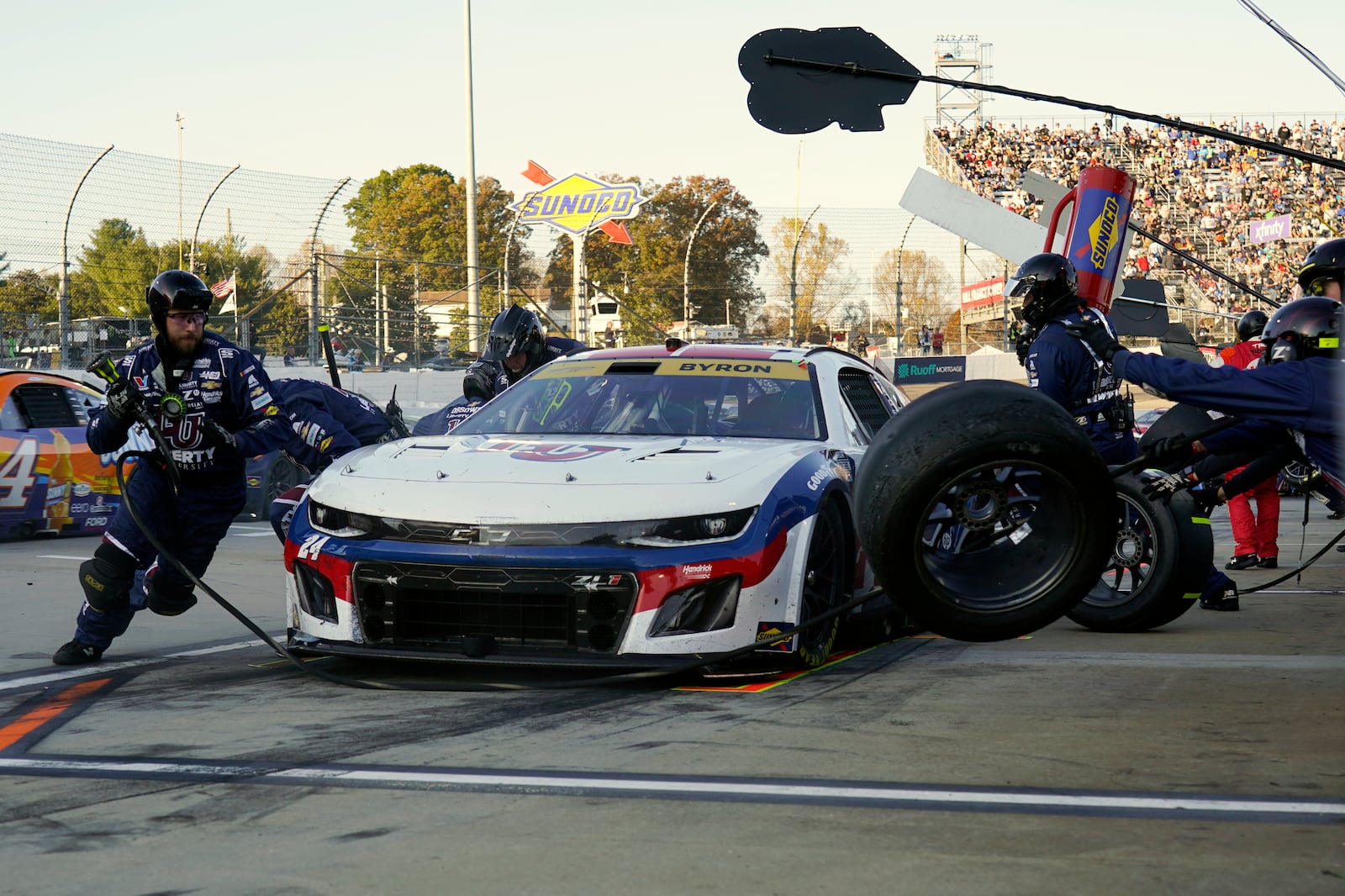 Crew members perform a pit stop on driver William Byron's car during a NASCAR Cup Series auto race at Martinsville Speedway in Martinsville, Va., Sunday, Nov. 3, 2024. (AP Photo/Chuck Burton)