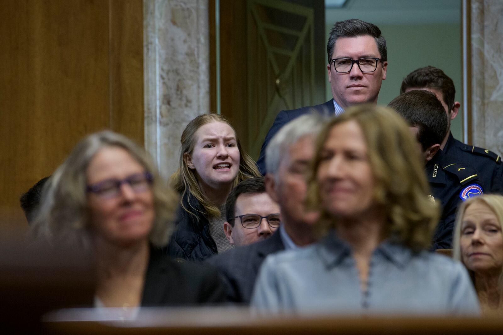 A protestor interrupts Chris Wright, President-elect Donald Trump's nominee to be Secretary of Energy, as he testifies during a Senate Committee on Energy and Natural Resources hearing for his pending confirmation, on Capitol Hill, Wednesday, Jan. 15, 2025, in Washington. (AP Photo/Rod Lamkey, Jr.)