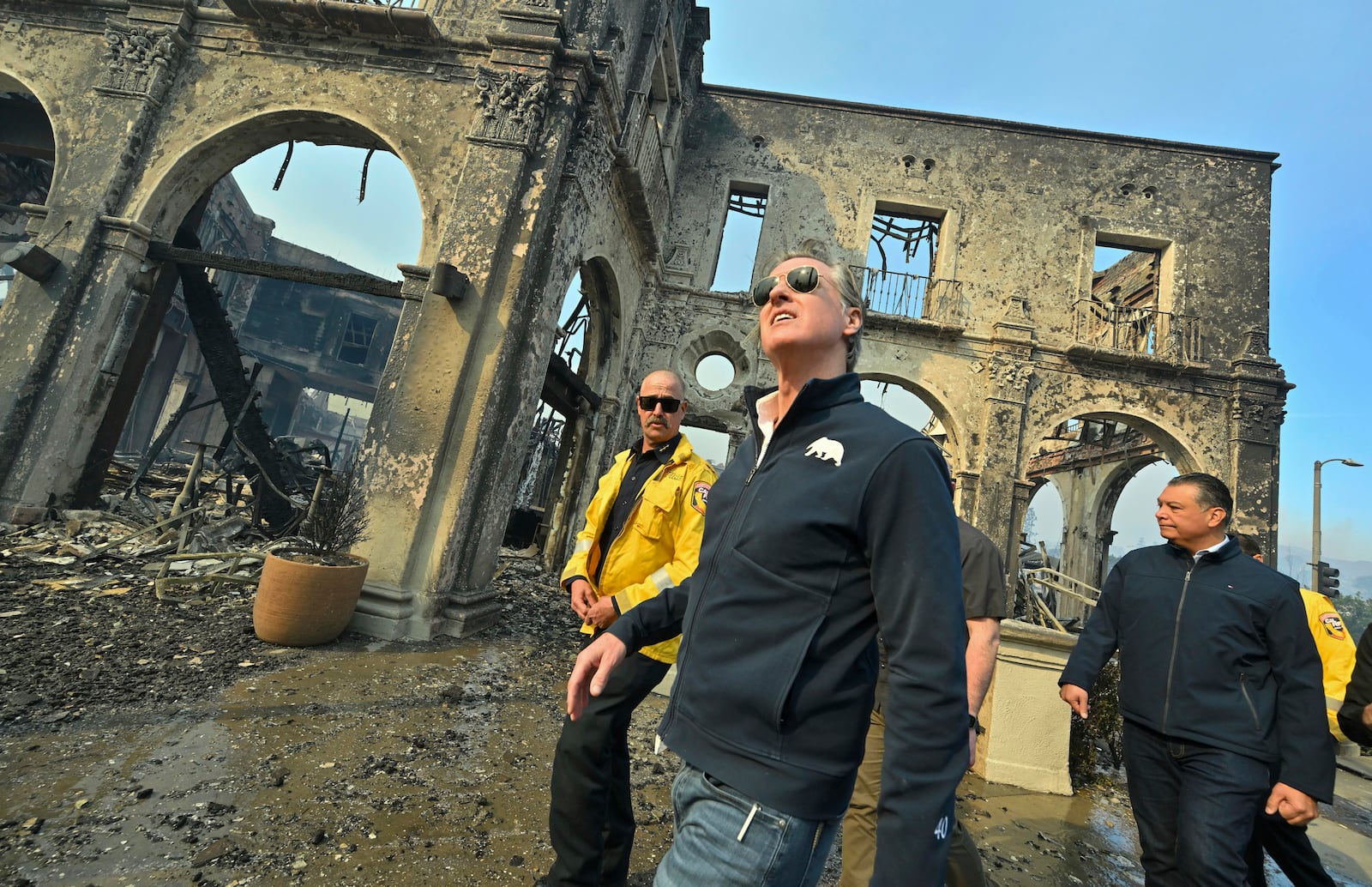 California Governor Gavin Newsom, center, surveys damage in Pacific Palisades with CalFire's Nick Schuler, left, and Senator Alex Padilla, D-Calif., during the Palisades Fire Wednesday, Jan. 8, 2025, in Pacific Palisades, Calif. (Jeff Gritchen/The Orange County Register via AP)