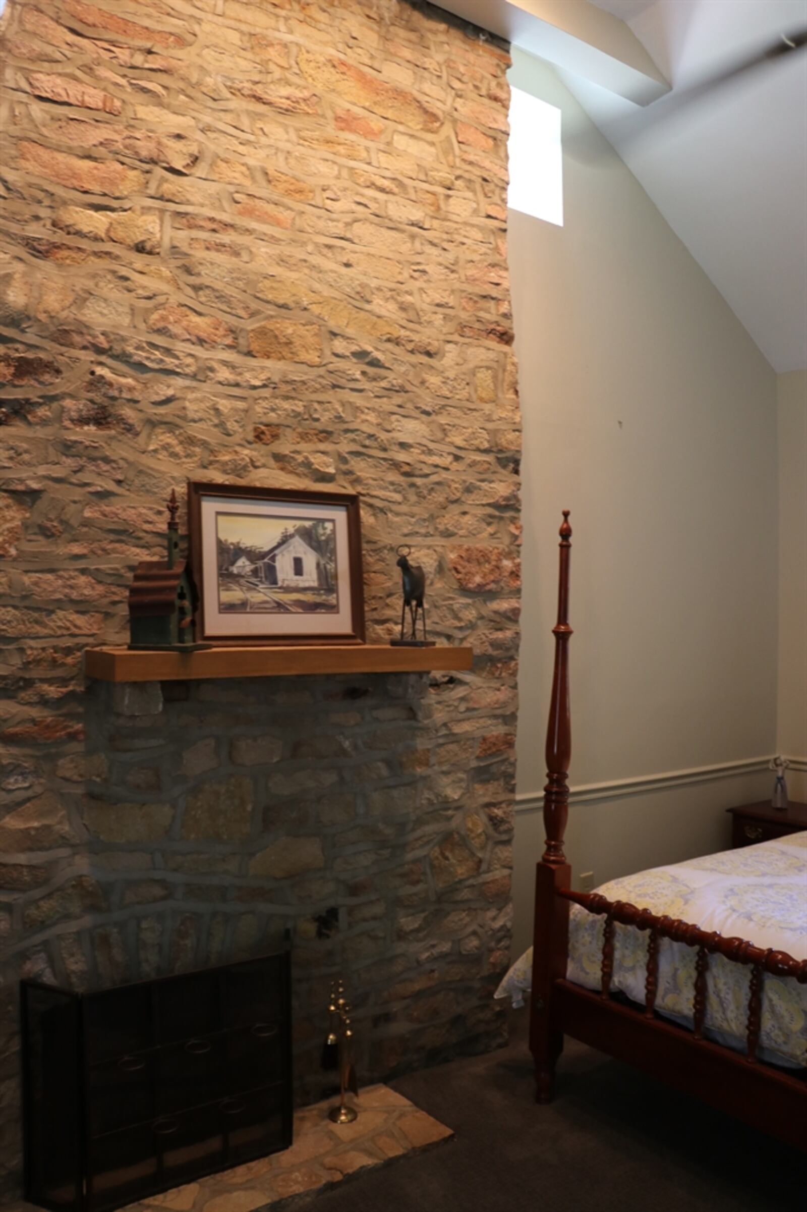 The main bedroom has an interior stone wall, barn-dome ceiling and a single-door closet. The private bath has soaking tub, a walk-in shower, a single-sink, ceramic-tile flooring. CONTRIBUTED PHOTO BY KATHY TYLER