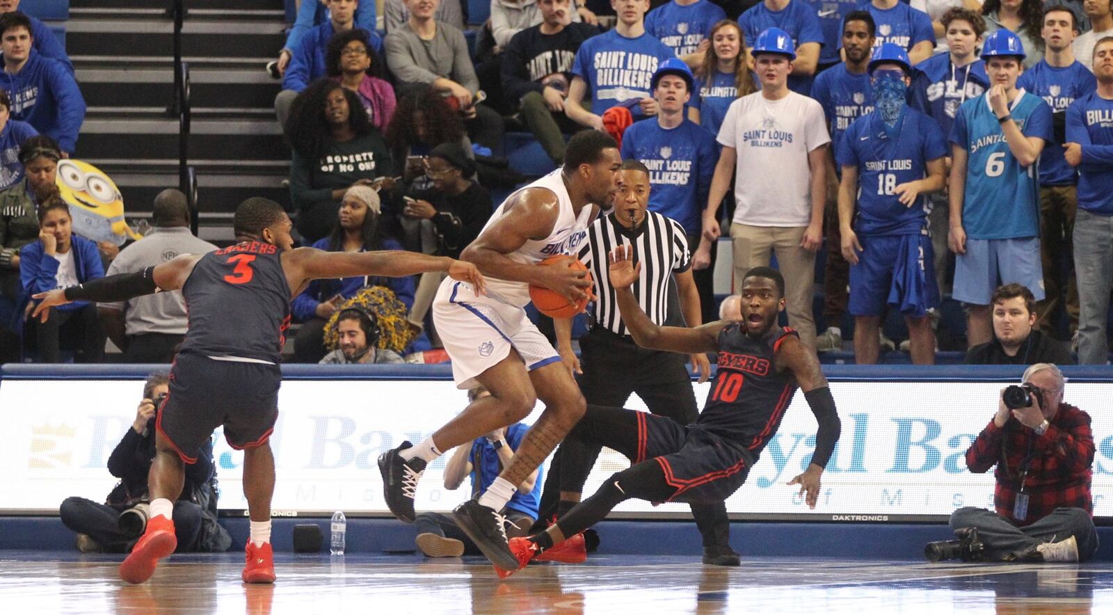 Dayton’s Jalen Crutcher takes a charge against Saint Louis guard Javon Bess on Tuesday, Feb. 5, 2019, at Chaifetz Arena in St. Louis. David Jablonski/Staff