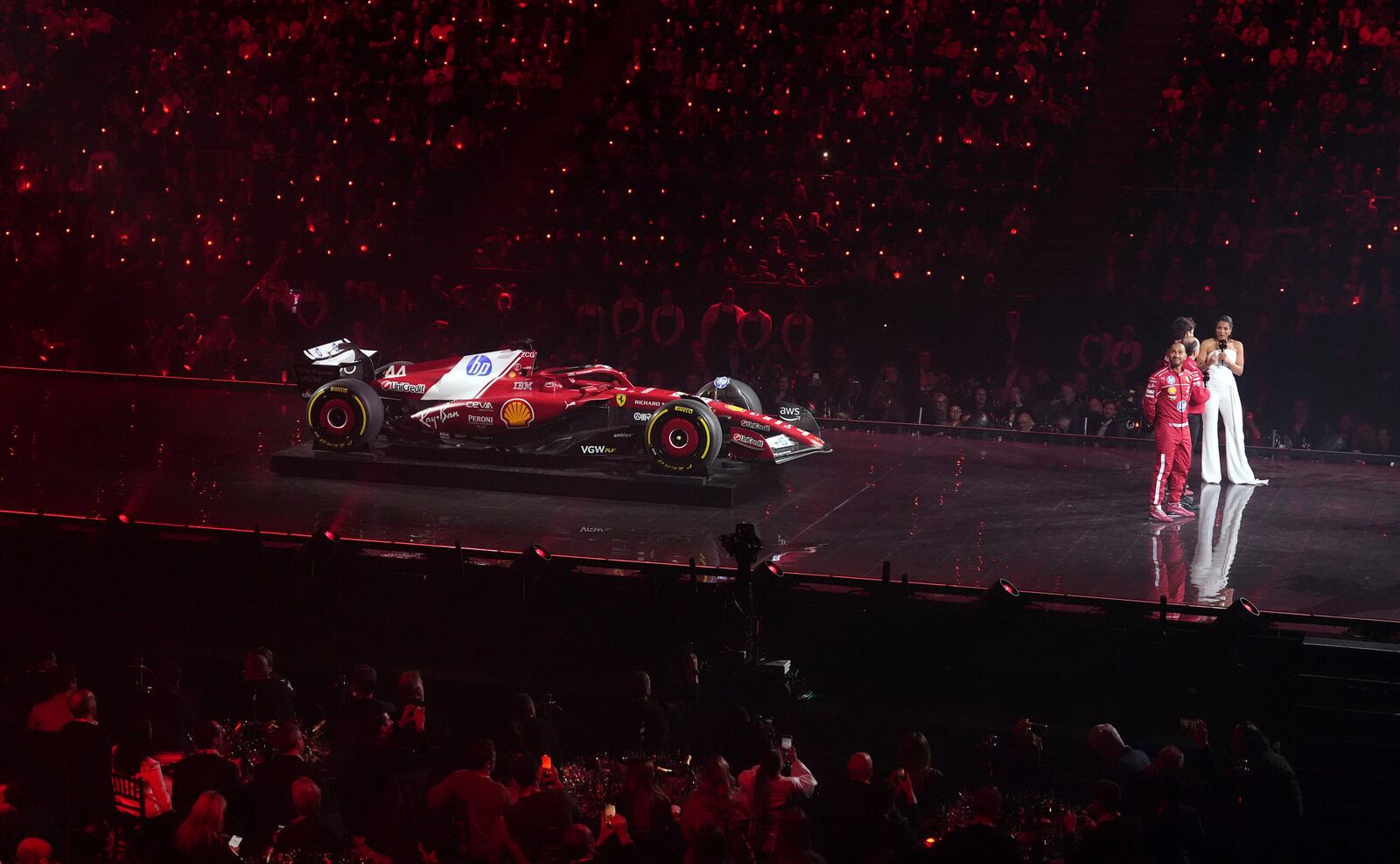 Ferrari driver Lewis Hamilton, front right, looks up during the F1 75 Live event at the O2 arena in London, England, Tuesday, Feb. 18, 2025. (Bradley Collyer/PA via AP)