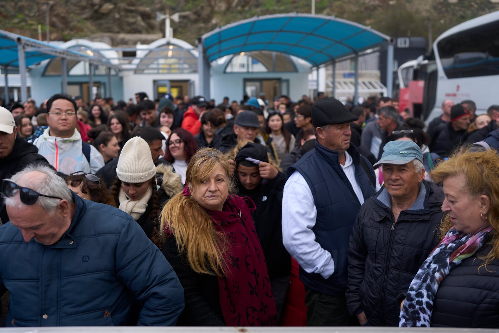 Passengers wait to board a ferry bound for the Greek mainland, in the earthquake-struck island of Santorini, Greece, Tuesday, Feb. 4, 2025. (AP Photo/Petros Giannakouris)