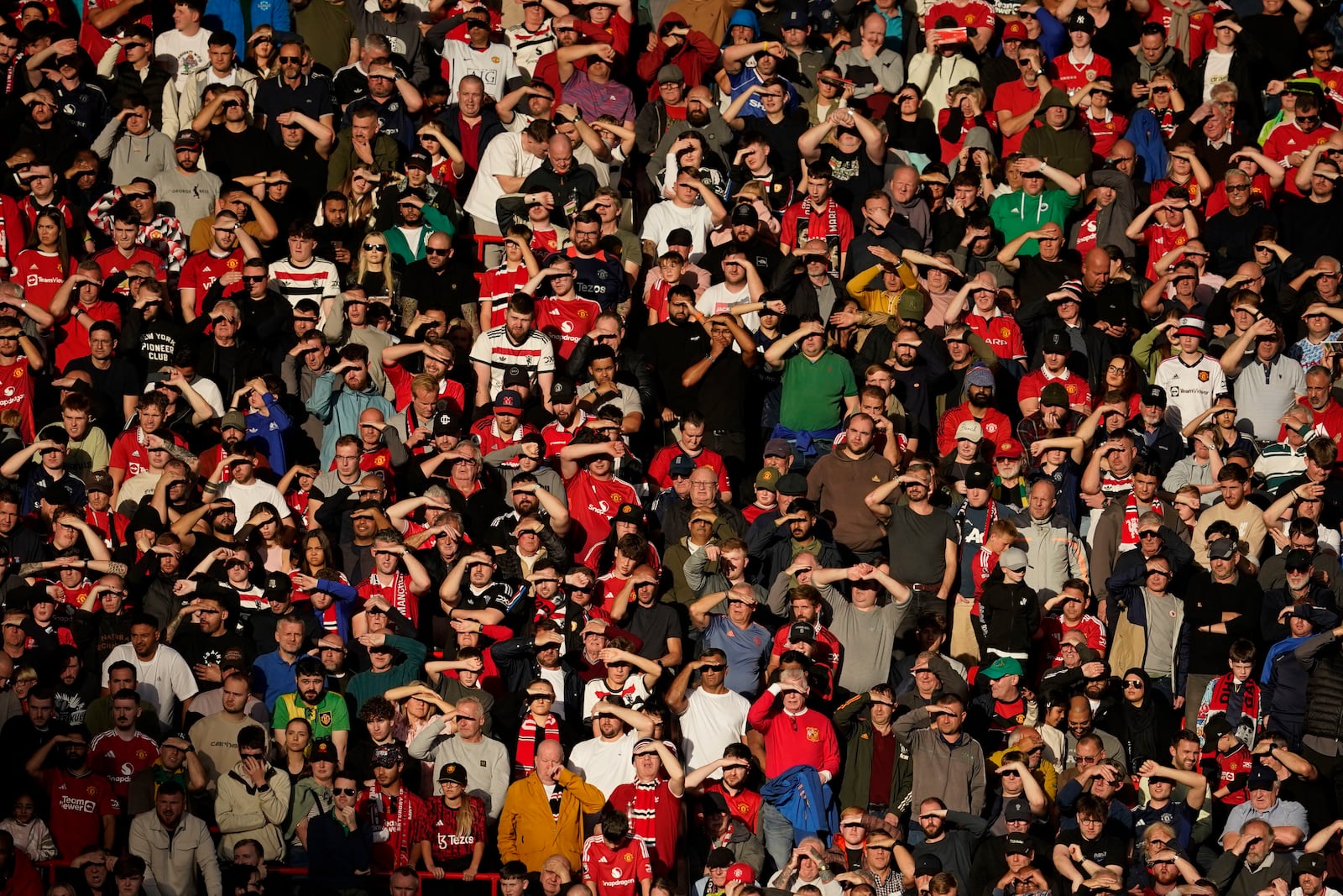 Fans watch from the stands during the English Premier League soccer match between Manchester United and Brentford at Old Trafford stadium in Manchester, England, Saturday, Oct. 19, 2024. (AP Photo/Dave Thompson)