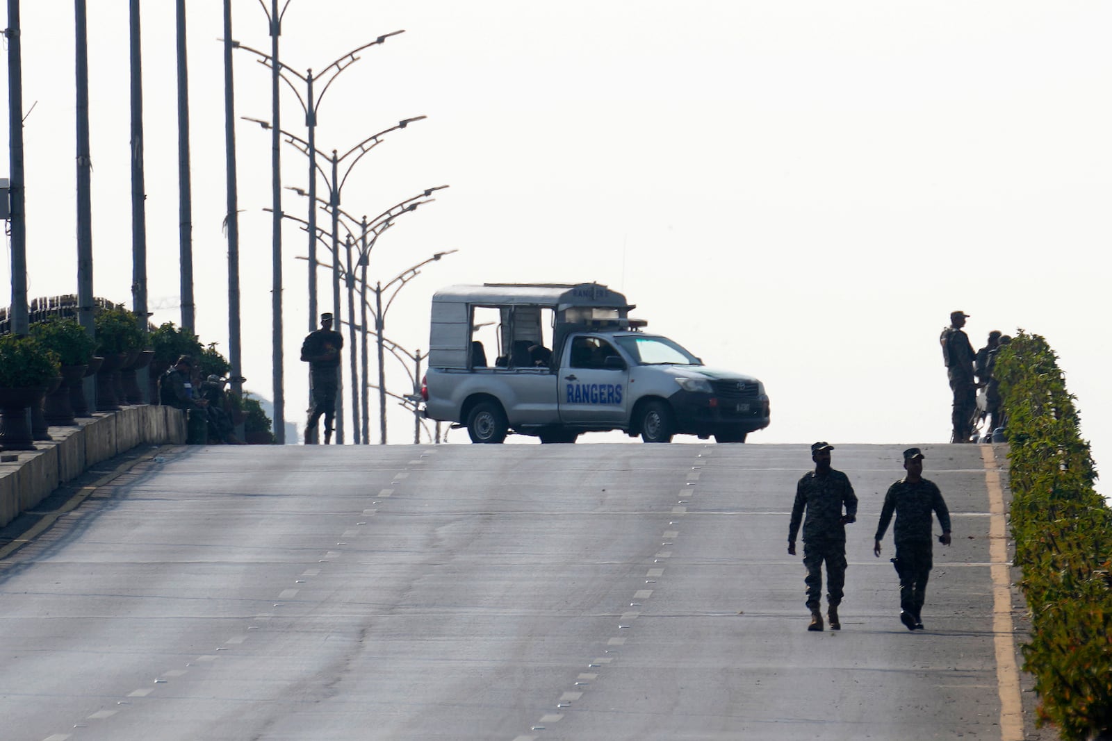 Paramilitary soldiers patrol as they station at a overhead bridge ahead of a planned rally by supporters of imprisoned former Prime Minister Imran Khan's Pakistan Tehreek-e-Insaf party, in Islamabad, Pakistan, Sunday, Nov. 24, 2024. (AP Photo/Anjum Naveed)