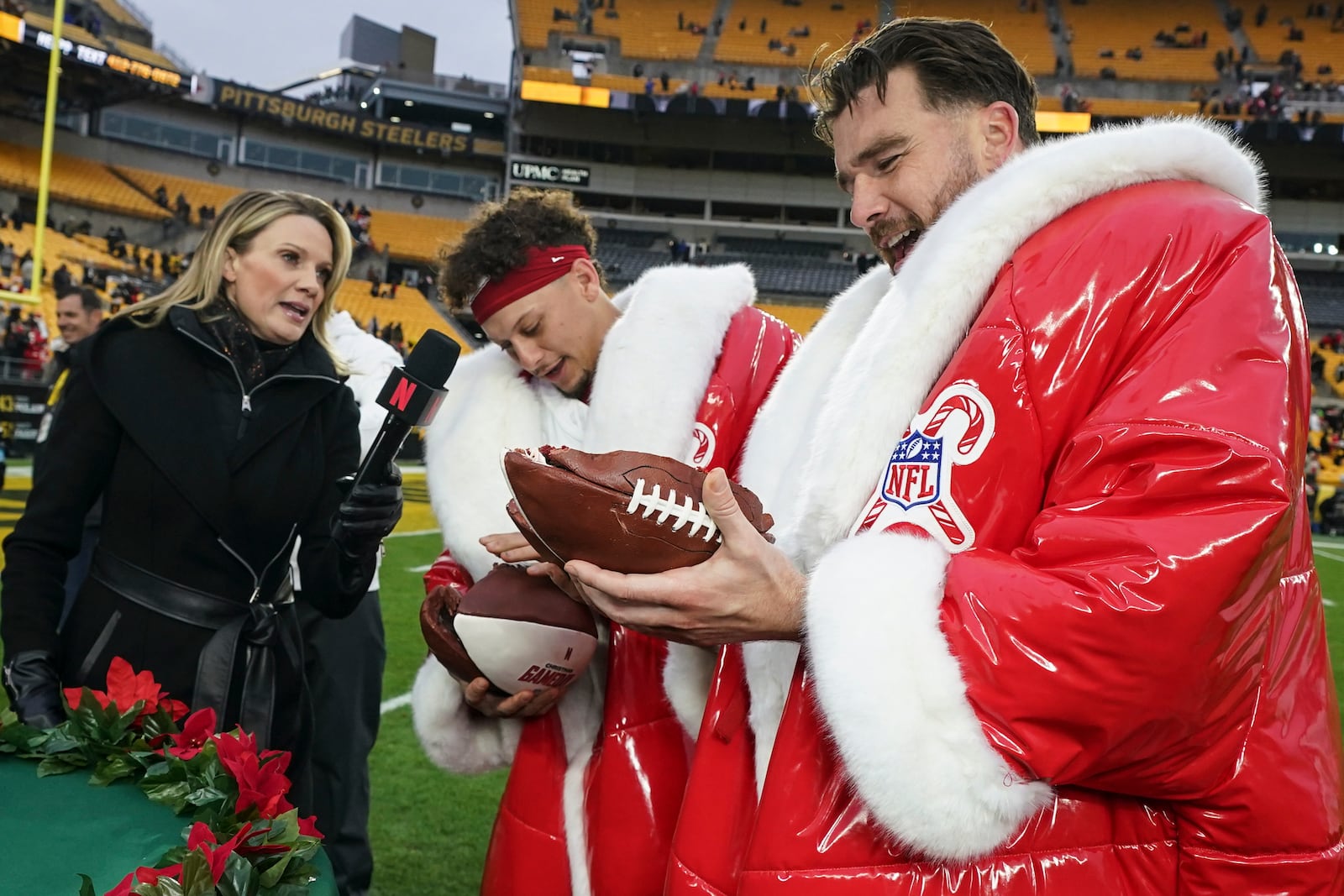 Kansas City Chiefs quarterback Patrick Mahomes and Travis Kelce speak after an NFL football game against the Pittsburgh Steelers, Wednesday, Dec. 25, 2024, in Pittsburgh. (AP Photo/Matt Freed)