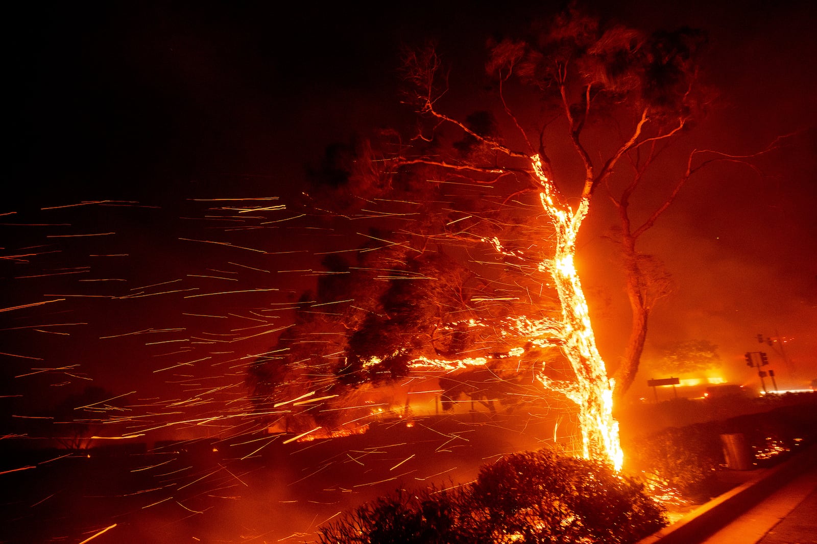 Embers fly as the Franklin Fire burns in Malibu, Calif., on Tuesday, Dec. 10, 2024. (AP Photo/Ethan Swope)