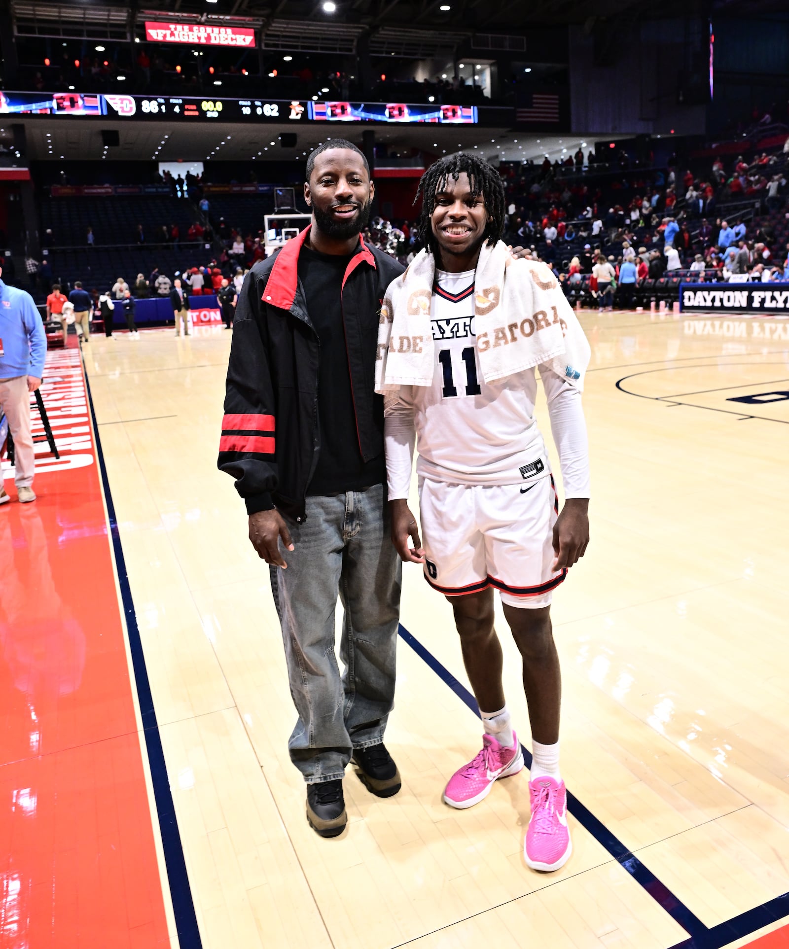 Former University of Dayton basketball great Scoochie Smith (left) and his younger brother Malachi after Saturday's game at UD Arena. Scoochie was inducted into the UD Athletic Hall of Fame at halftime. Erik Schelkun/UD Athletics photo